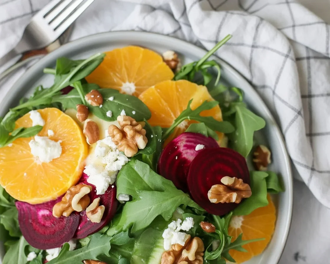 Colorful Beet and Orange salad with fresh herbs and roasted ingredients.
