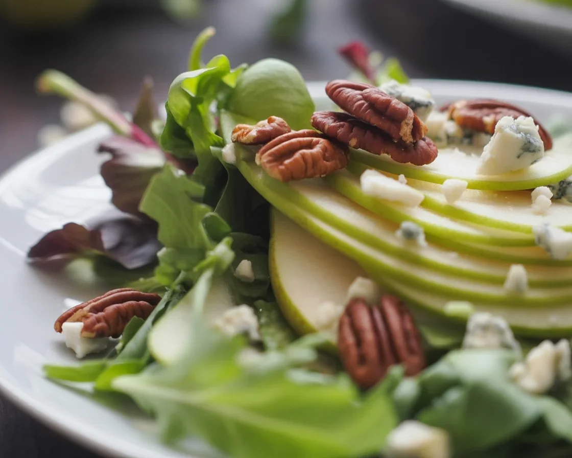 Pear and Gorgonzola Salad with candied pecans on a bed of greens