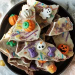 Delicious White Chocolate Halloween Oreo Bark with crushed Oreo cookies and colorful sprinkles.