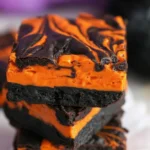 Halloween Cream Cheese Swirl Brownies with chocolate and orange cheesecake layers