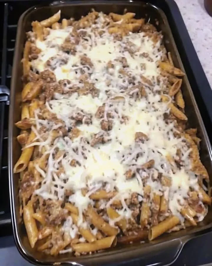 Delicious serving of Grandma's Hamburger Casserole topped with cheese and herbs