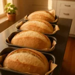 Freshly baked no knead sandwich bread loaf on a wooden cutting board