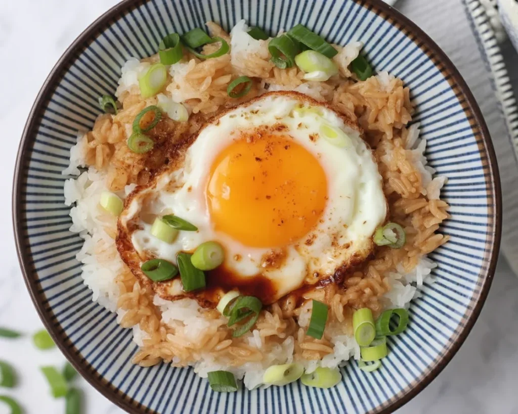 Easy Gyeran Bap - Delicious Korean Egg Rice topped with a fried egg and drizzled with soy sauce.