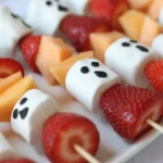 Delicious Halloween Ghost Fruit Skewers with strawberries and marshmallows