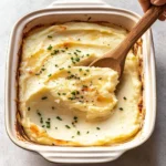 Delicious Baked Mashed Potatoes served in a creamy casserole dish