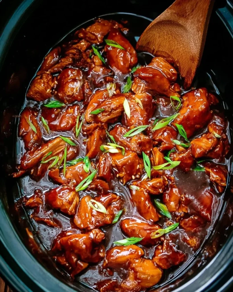 Delicious bourbon chicken served on a plate with rice and vegetables