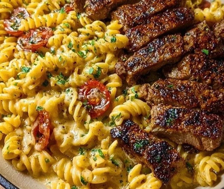 Cheesy Cajun steak pasta in garlic parmesan sauce served in a bowl