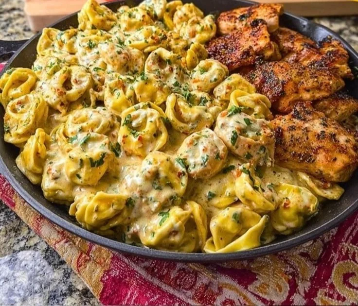 Creamy Cajun Chicken Tortellini with Velveeta garlic cheese sauce in a bowl