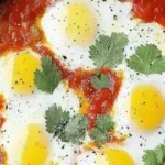 Delicious shakshuka served in a skillet, perfect for a cozy breakfast for two.