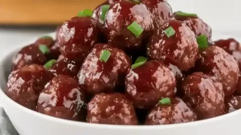 Slow cooker grape jelly meatballs served on a platter