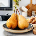 Delightfully sweet poached pears served with syrup and garnished with mint.