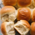 Delicious homemade dinner rolls fresh out of the oven, golden brown and soft.