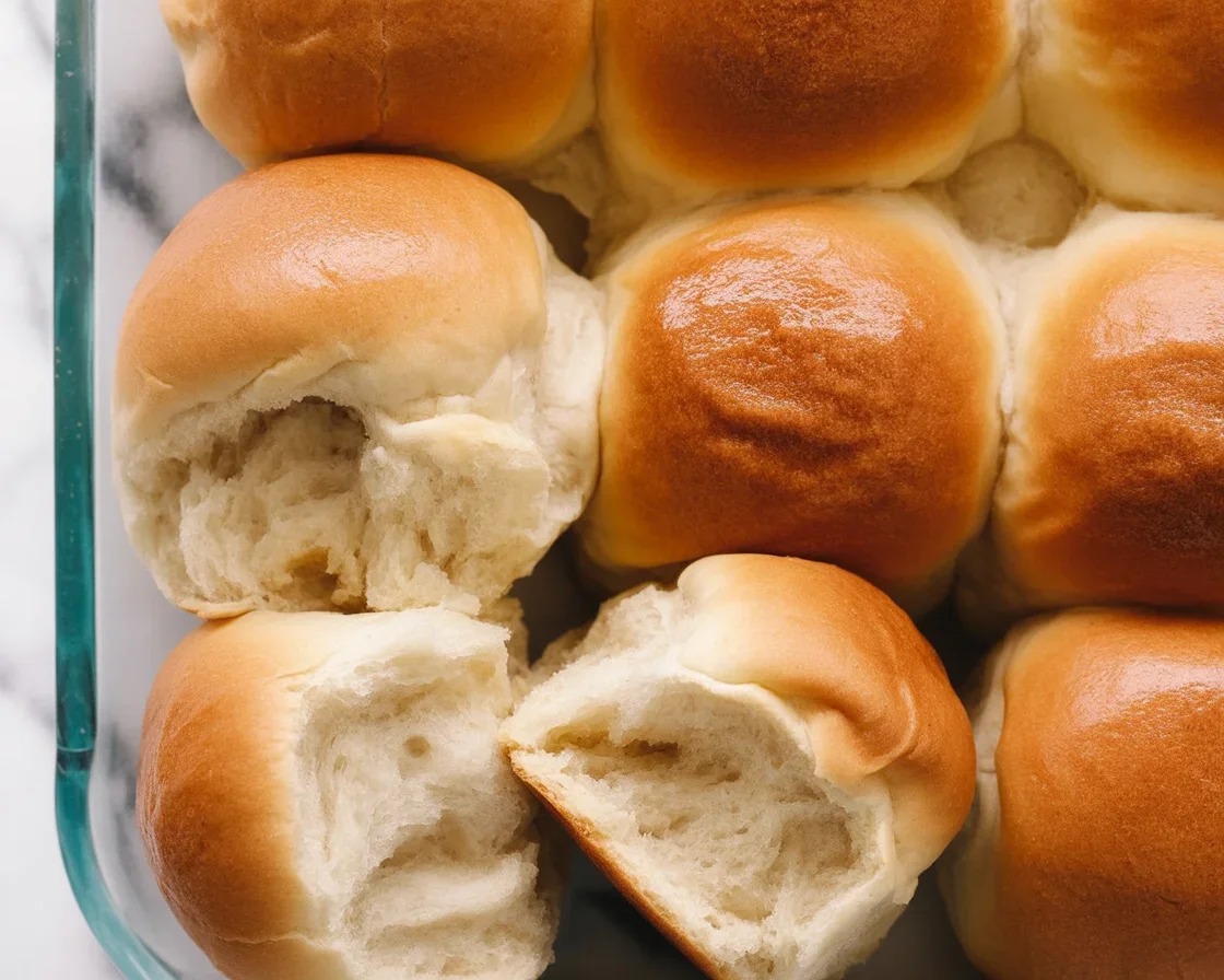 Delicious homemade dinner rolls fresh out of the oven, golden brown and soft.