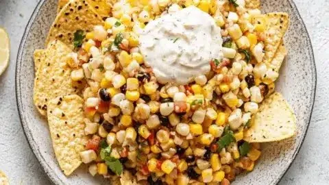 Vibrant grilled Mexican street corn salsa in a bowl, garnished with fresh cilantro.