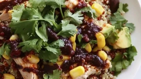 Healthy BBQ chicken quinoa salad with fresh vegetables and dressing