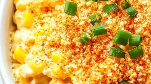 Bowl of homemade Parmesan Creamed Corn with cheese and herbs.