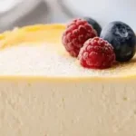 Irresistible New York Style Cheesecake topped with fresh berries