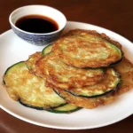 Plate of Korean zucchini fritters garnished and ready to eat