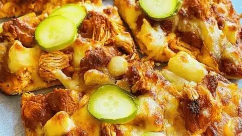 Delicious Nashville hot chicken flatbreads topped with spicy sauce and fresh herbs.