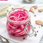 Pickled Red Onions in a glass bottle