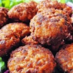 Plate of Romanian Fried Meatballs (Chiftele) with herbs and dipping sauce