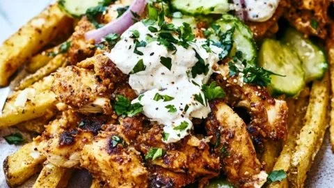 Delicious plate of savory chicken gyro fries topped with fresh ingredients