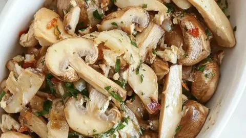 Bowl of simple marinated mushrooms ready to serve.