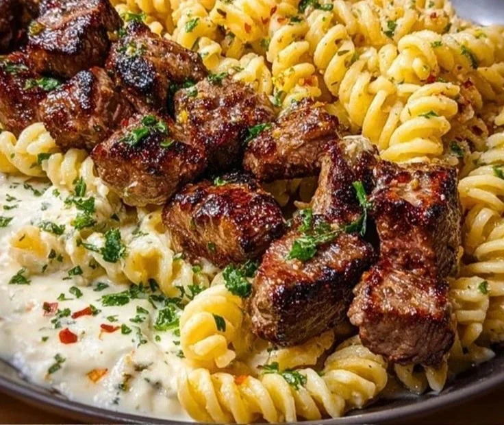Delicious steak bites served with cheesy rotini pasta.