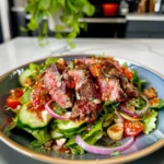 Delicious steak salad with grilled steak, fresh greens, and vibrant toppings.