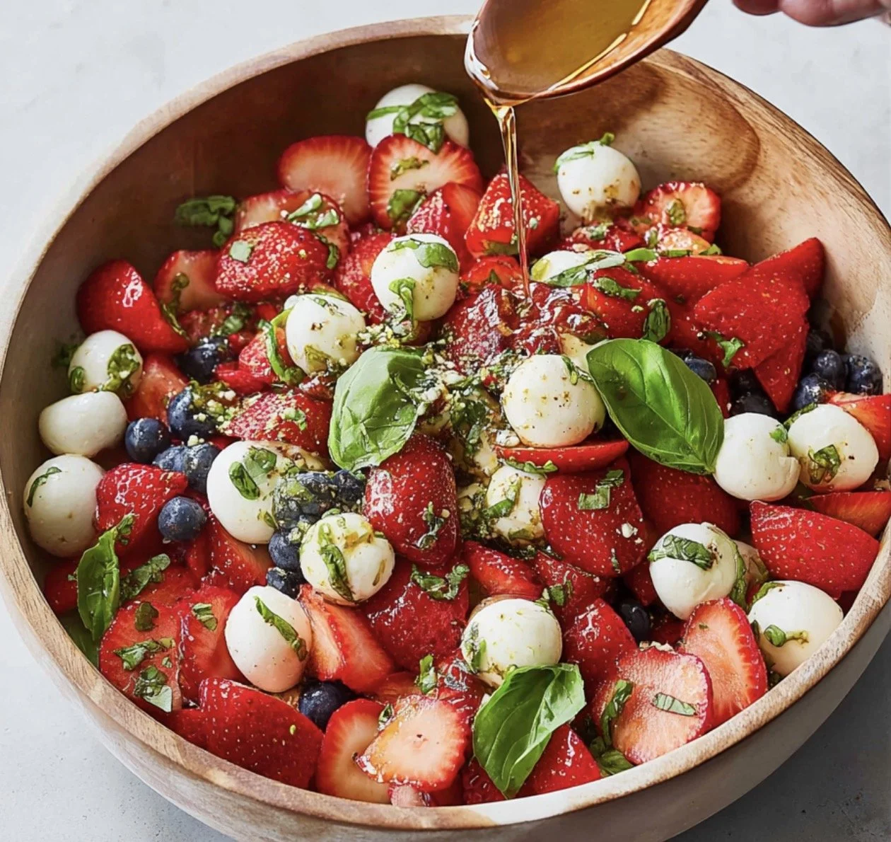 Fresh Strawberry Caprese Salad with mozzarella and basil on a plate