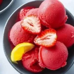Delicious handmade Strawberry Sorbet in a bowl with fresh strawberries