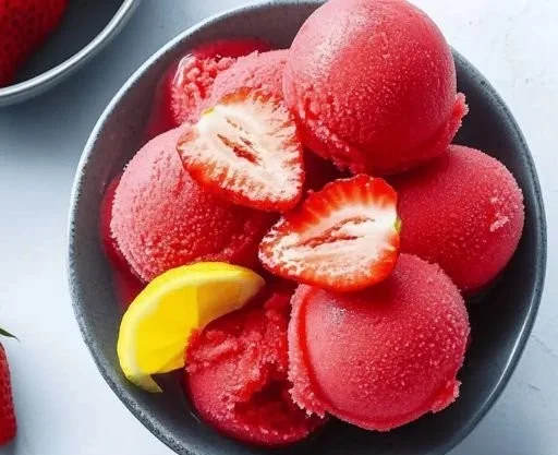 Delicious handmade Strawberry Sorbet in a bowl with fresh strawberries
