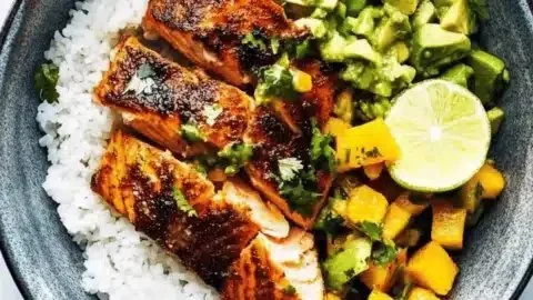 BBQ salmon bowls with mango avocado salsa served in a bowl on a wooden table