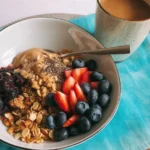 Loaded cereal bowl with fruits, nuts, and toppings for a nutritious breakfast