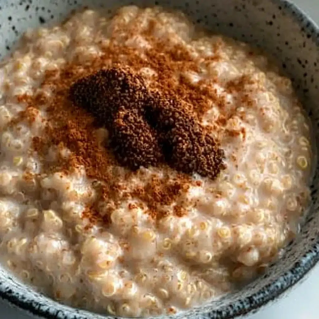 Creamy quinoa pudding with coconut milk and maple syrup served in a bowl.