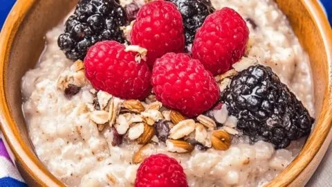 Creamy wild rice pudding with maple syrup and fresh fruits served in a bowl