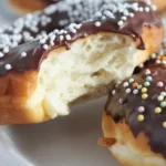 Delicious air fryer gluten-free donuts topped with chocolate glaze and cinnamon sugar.
