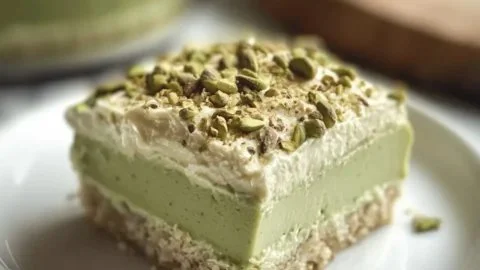 Decadent dairy-free pistachio tres leches dessert topped with nuts