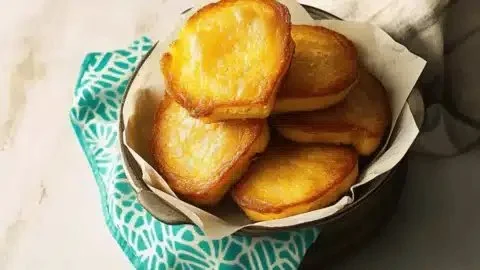 Golden crispy fried cornbread served on a rustic plate