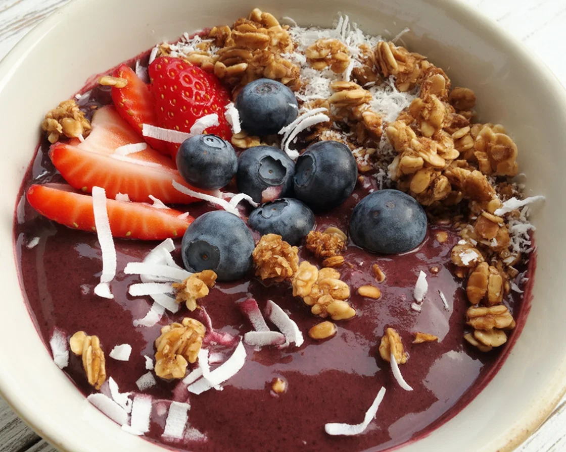 Colorful collagen smoothie bowl topped with fresh fruit and nuts for nutrition.