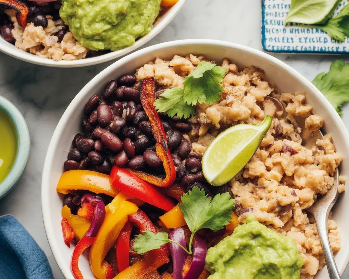 Colorful cauliflower rice bowl with sweet potatoes, veggies, and chickpeas.