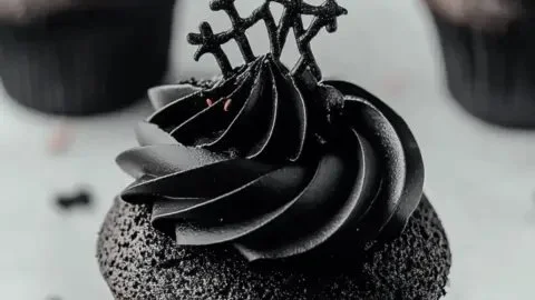 Black velvet cupcakes topped with cream cheese frosting for Halloween parties