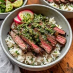 Delicious skirt steak rice bowl garnished with chimichurri sauce.