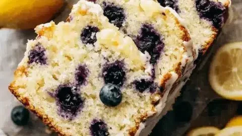 Zesty lemon blueberry loaf garnished with blueberries and lemon zest