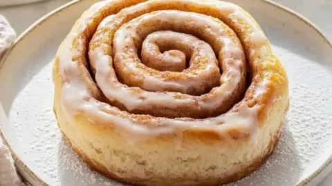 Delicious milk bread cinnamon rolls with chai glaze on a plate