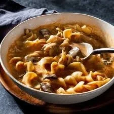 Bowl of delicious paprika chicken soup garnished with herbs
