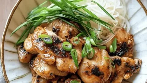 Close-up of a delicious chicken bulgogi dish garnished with vegetables and sesame seeds.