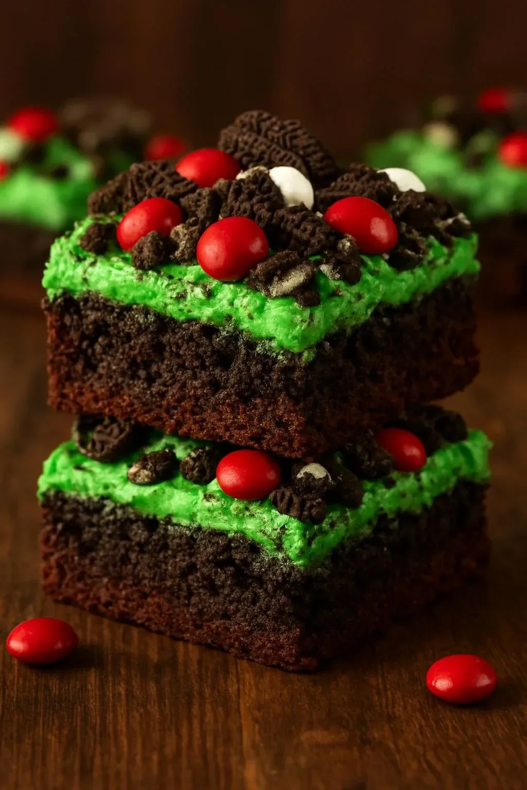 Delicious Grinch Brownies decorated with green frosting and festive sprinkles.