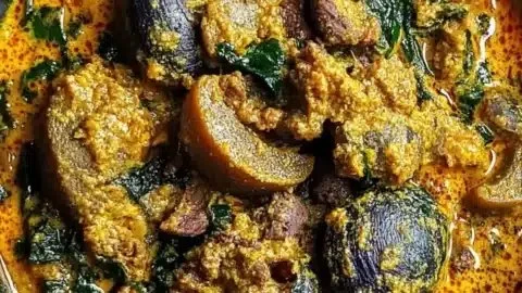 Hearty Nigerian Egusi dish with beef and periwinkles served in a bowl