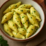 Plate of homemade kreplach dumplings, filled with savory meat and served warm.